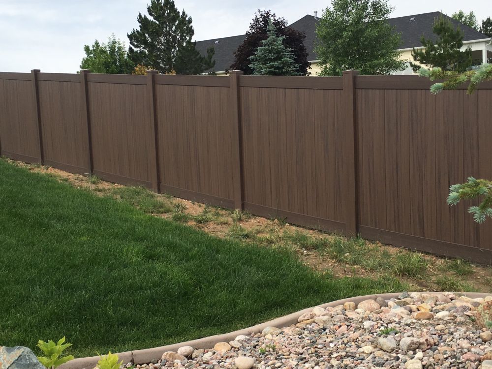 Woodgrain vinyl privacy fence installed near Idaho Falls, Idaho